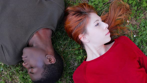 lack of communication.Interracial couple lying  turning head in opposite side