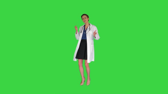 Female Doctor Dancing Concept: Profession, Medecine, Medical Education on a Green Screen, Chroma Key