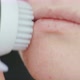 Young woman cleaning face using cosmetic face brush. Facial. Cosmetic procedures. - VideoHive Item for Sale
