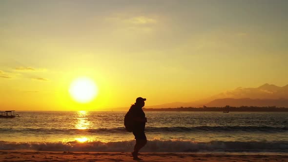 Female model happy and smiling on marine coast beach voyage by clear lagoon with bright sand backgro