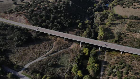 Modern elevated road near ancient roman bridge, Vila Formosa in Portugal. Aerial backward