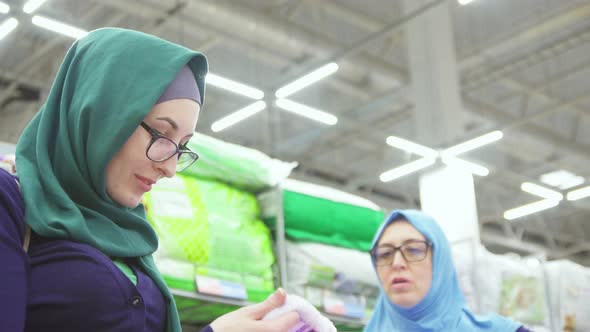 Two Beautiful Muslim Women Shoppingchoose Textiles Close Up