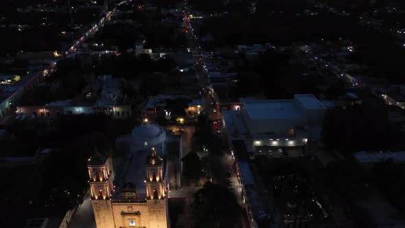 High night time aerial descent in front of Catedral de San Gervasio in Valladolid, Yucatan, Mexico.