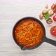 Cooking homemade pasta with tomato sauce in cast iron pan served with chili pepper, fresh basil - VideoHive Item for Sale