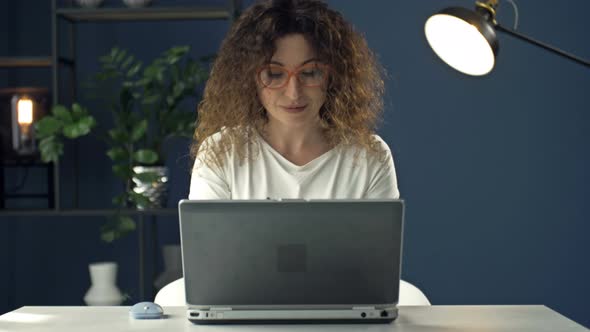 Portrait of a Middleaged Woman Working at a Laptop