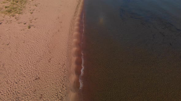 Aerial Top View Of Sand And Waves Of Lake Superior 