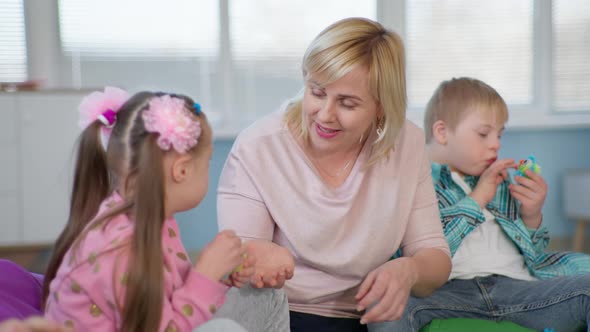 Female Teacher Working with Children with Down Syndrome for Lesson in an Inclusive School