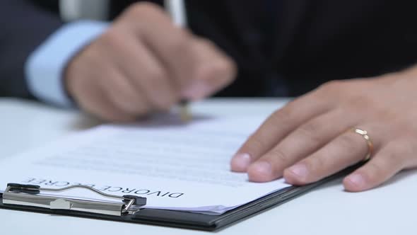 Man Signing Up Divorce Degree, Taking Off Engagement Ring From Finger, Break-Up