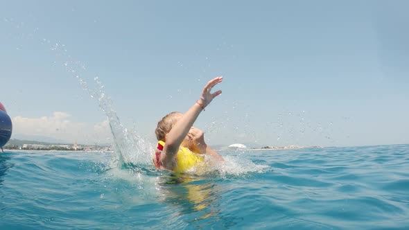 Little Girl on Water Attraction During Summer Holiday.