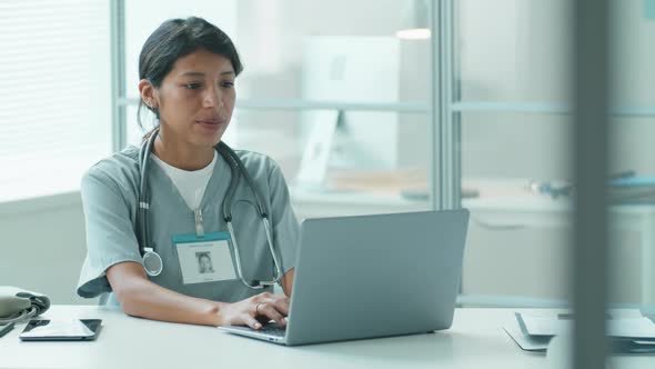 Portrait of Hispanic Female Doctor at Work in Medical Office
