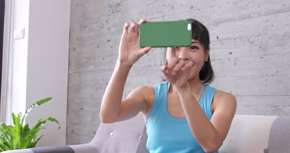 Woman Watching Movie on Mobile Phone at Home