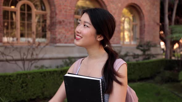 Asian female college student walking  to her class