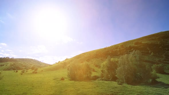  UHD Mountain Meadow Timelapse at the Summer. Clouds, Trees, Green Grass and Sun Rays Movement.