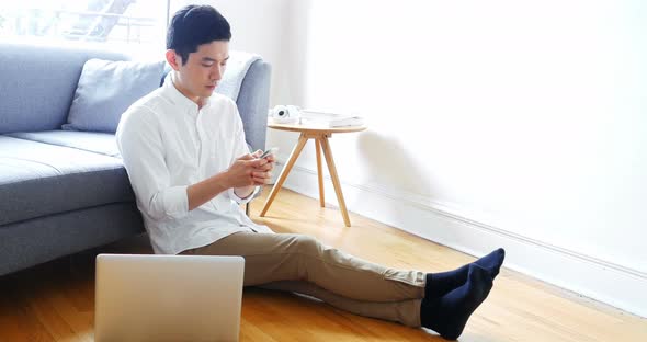 Man using mobile phone in living room 4k