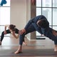 Man and Woman Practice Synchronously Stretch Exercise in Yoga Studio - VideoHive Item for Sale
