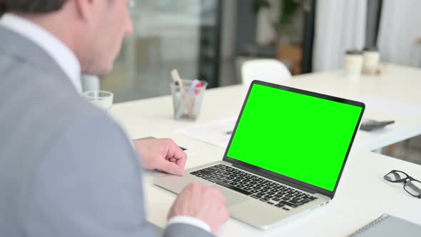 Businessman Using Laptop with Green Chroma Key Screen