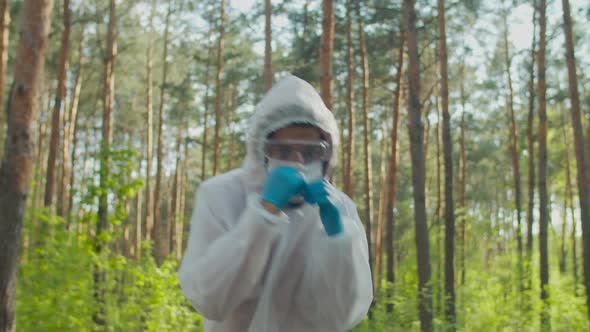 Man in Biohazard Suit Throwing Punches in Nature