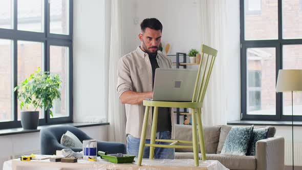 Man with Laptop Preparing Old Chair for Renovation