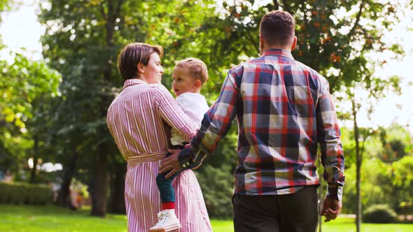 Happy Family Walking at Summer Park