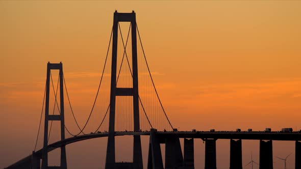 Great Belt Bridge View Against Orange Sky at Dawn