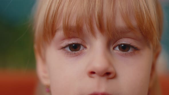 Portrait Young Child Girl Kid Looking at Camera Eyes Closeup Macro Looking To Camera Indoors