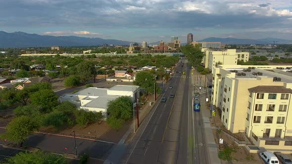 Drone shot following the Sun Link streetcar in Tucson Arizona, rotating and rising