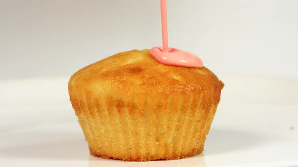 Pouring Pink Icing Over Cake