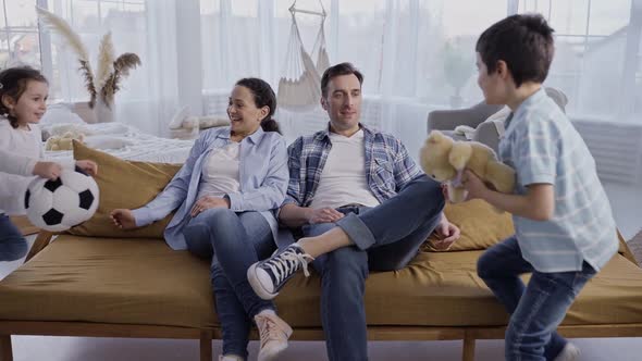 Happy Loving Family with Kids Relaxing on Sofa