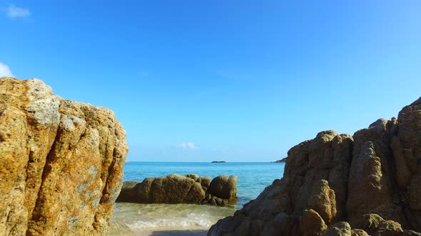 Wide birds eye island view of a paradise sunny white sand beach and blue ocean background in colourf