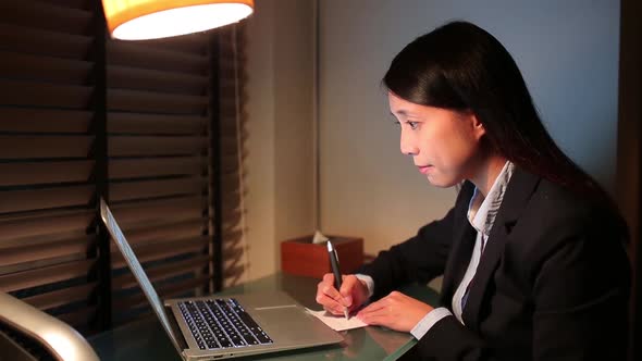 Business woman working with laptop computer at night