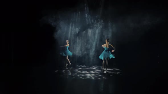 Two Ballerinas Spin on the Stage