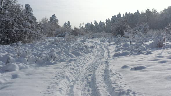 Slow descending on snowed path 4K aerial video