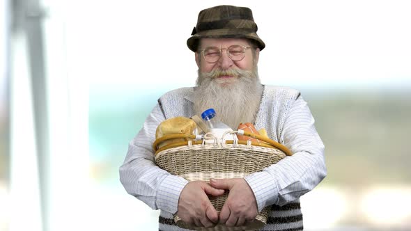 Elderly Farmer with Dairy Products on Blurred Background.