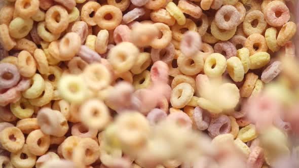 Close Up of Dropping Colorful Cereal Corn Flakes in a Bowl