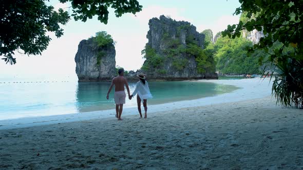 Couple Men and Woman on the Beach of Koh Hong Island Krabi Thailand Asian Woman and European Men on