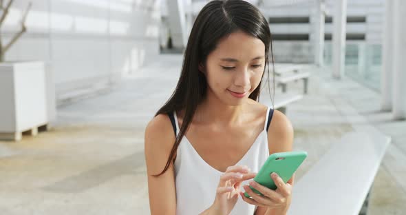 Woman use of phone at outdoor 