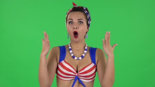 Portrait of Beautiful Surprised Girl in a Swimsuit Is Saying Oh My God and Being Shocked. Green