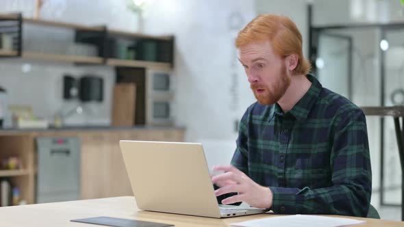 Excited Beard Redhead Man Celebrating Success on Laptop