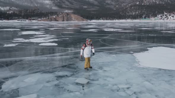 Aerial View of Man Skating on Lake Baikal Covered By Ice