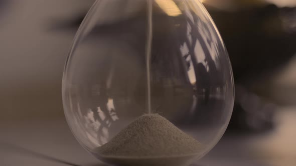 Hourglass sand falling in slow motion