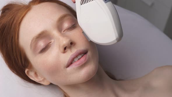 Young Woman in the Office of a Cosmetologist Receives Hardware Laser Rejuvenation of the Skin