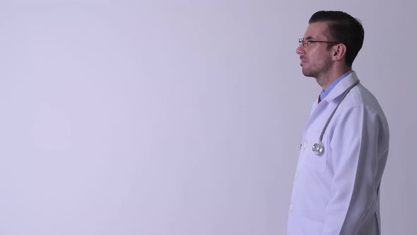 Profile View of Young Hispanic Man Doctor Thinking