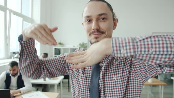 Funny Young Man Dancing Moving Arms Then Walking to Workplace in Office