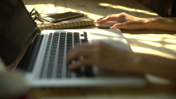 Using Laptop On Wooden Desk