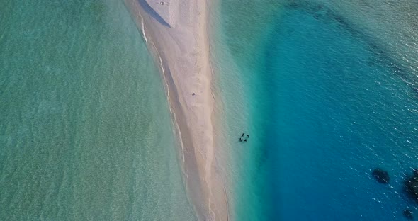 Natural birds eye abstract shot of a paradise sunny white sand beach and aqua blue water background 