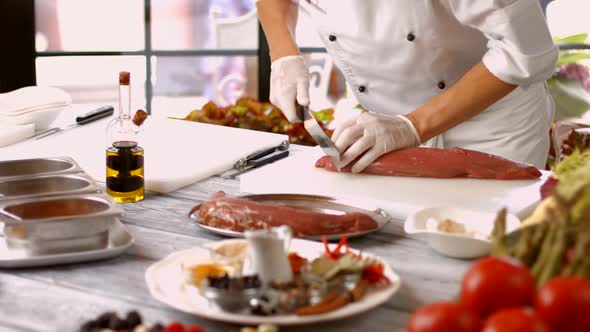 Man Cuts Meat with Knife.