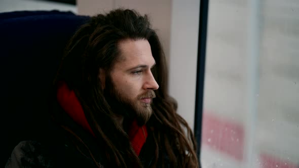 Portrait of a Cute Bearded Homosexual Man on a Train Looking Out the Window