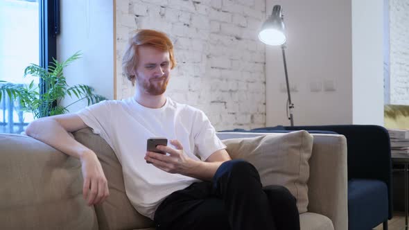 Redhead Creative Designer Upset for Loss while Using Smartphone