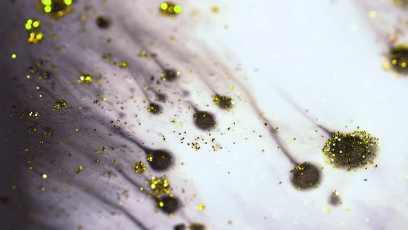 Macro Close Up Shot Of Golden Wet Glitter. Golden Space Glittering Particle Background. 