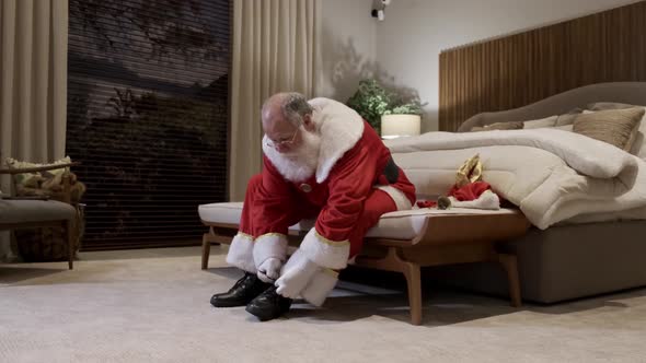 Santa Claus getting dressed for Christmas night. Putting on your clothes. Cinematic 4K.